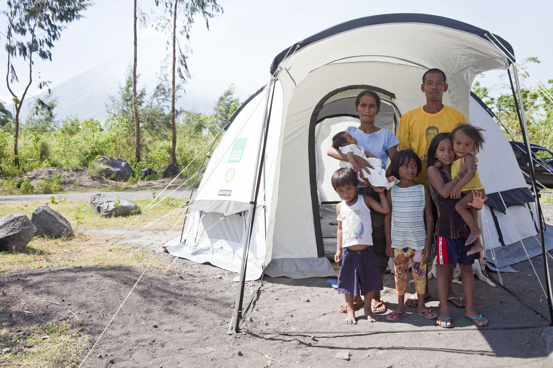 Happy beneficiary family outside of Legazpi, Philippines followiong Typhoon Albay 2014